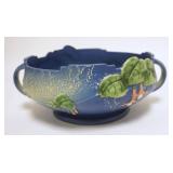 1073	ROSEVILLE FUCHSIA BLUE BOWL, 10 3/4 IN ACROSS THE HANDLES, HAS A RIM CHIP 