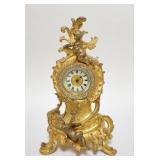 1221	ANSONIA GILT METAL DRESSER CLOCK W/PUTTI, PATENTED MAY 3, 1892, JEWELS AROUND THE FACE, 10 IN H