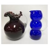 1265	2 BLOWN GLASS PITCHERS AMETHYST & BLUE. TALLEST IS 5/8 IN 
