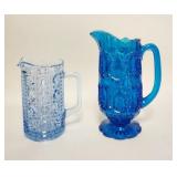 1293	2 BLUE GLASS PITCHERS, TALLEST IS 8 IN 
