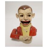 1031	ALUMINUM MECHANICAL BANK, BOY THROWS COINS IN HIS MOUTH, PAINT DECRATED, EYES CLOSE & EARS WIGG