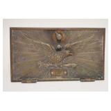 1065	BRASS PO BOX DOOR W/SPREAD WING EAGLE MOUNTED TO A STAND, 11 IN X 6 1/4 IN
