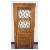 1154	OAK DOOR W/FRETWORK CUT OUTS, ORNATE BRASS HARDWARE, ONE SMALL BREAK IN THE FRETWORK, 31 IN X 7