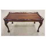 1011	MAHOGANY BALL & CLAW FOOT COFFEE TABLE HAS A FRETWORK GALLERY & CARVED KNEES. 35 1/2 IN X 18 1/