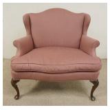1024	CARR & COMPANY WIDE UPHOLSTERED ARMCHAIR. 38 IN W, 35 IN H HAS A HUMP BACK & SHELL CARVED CREST