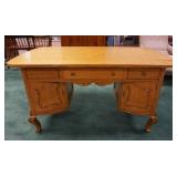 1047	DIMINUTIVE TYPE OAK PARTNERS DESK HAS CARVED TRIM & BRASS TRIM ON THE FEET. 52 IN X 28 IN, 28 1