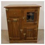 1049	CONTEMPORARY OAK ICE BOX HAS A WINE RACK SECTION. 3 DOORS ONE GLASS & A DRAWER. 31 IN W 18 IN D