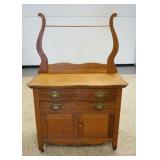1052	OAK WASHSTAND W/ TOWEL BAR SERPENTINE TOP DRAWER. 35 1/2 IN W, 17 IN DEEP 55 1/4 IN H 