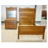 1053	SPOON CARVED OAK HIGH BACK BED & DRESSER W/ MIRROR LOT ALSO INCLUDES A CANE BACK BOUDIOR CHAIR.
