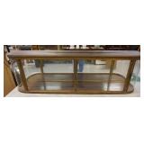 1148	LONG TABLE TOP SHOWCASE W/CURVED SIDE GLASS, BRONZE/BRASS, MIRROR BACK, TOP BOARD IS SPLIT, 67 