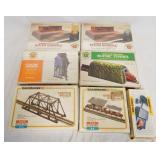 1223	LOT OF 6 BACHMANN BUILDING KITS PLUS A N-HO POWER BACK. 5 OF THE 6 KITS ARE SEALED IN BOX.