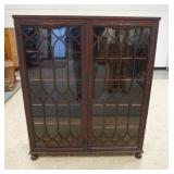 1172	MAHOGANY BOOKCASE W/LATTICE WORK DOUBLE DOORS ON BUN FEET, 48 IN X 14 IN X 57 IN