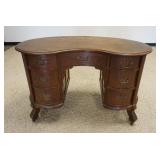 1043	OAK KIDNEY SHAPED DESK W/REEDED FRONT COLUMNS, APPROXIMATLEY 48 IN X 3 IN X 31 IN HIGH, STAININ