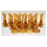1085	23 AMBER FOSTORIA COIN GLASS CANDLESTICKS, INCLUDES TWO SIZES. TALLEST 8 IN H 