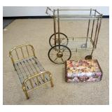 1130	3 PIECE LOT W/GLASS & BRASS TEACART, BRASS DOLL BED, & A DECOUPAGE SUITCASE, TEACART IS 33 IN W