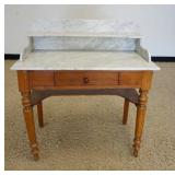 1139	MARBLE TOP ONE DRAWER TABLE, HAS MARBLE SPLASH & SHELF, TURNED LEGS, 35 1/2 IN WIDE X 17 1/4 IN