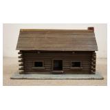 1216	MODEL LOG CABIN, BACK OF ROOF LIFTS UP, BASE IS 33 1/4 IN X 13 IN, 19 IN HIGH