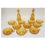 1290	12 PIECE AMBER FOSTORIA COIN, 2 DECANTERS, ONE W/SRONG STOPPER & 10 HANDLED NAPPIES