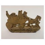 1007	CAST IRON DOORSTOP ENGLISH COACH SCENE, MARKED ON REVERSE WH HOWELL CO, APPROXIMATELY 7 IN X 4 
