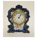 1027	SETH THOMAS CHINA CLOCK *LILY* APPROXIMATELY 3 1/4 IN X 6 1/2 IN X 7 3/4 IN HIGH