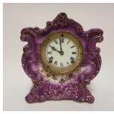 1083	ANSONIA ROYAL BONN LAVENDAR CHINA CLOCK *WINER* APPROXIMATELY 5 1/2 IN X 9 IN X 11 1/4 IN HIGH