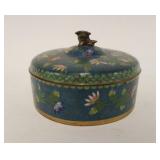 1094	CLOISONNE ROUND COVERED BOX W/FOO DOG MOUNTED AT TOP, APPROXIMATELY 8 IN X 3 1/2 IN, SMALL CHIP