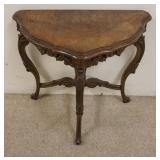 1111	CARVED WALNUT DEMILUNE STAND W/BURL WOOD VENEER TOP, APPROXIMATELY 24 IN X 14 IN X 23 IN HIGH