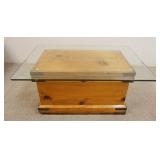 1138	PRIMITIVE PINE CHEST UTILIZED AS A GLASS TOP COFFEE TABLE, APPROXIMATELY 36 IN X 24 IN X 16 3/4
