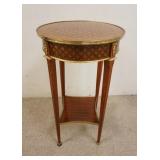 1151	ROUND MAHOGANY ONE DRAWER STAND W/DIAMOND QUILTED INLAID TOP & SIDES BRONZE TRIM & MOUNTS, APPR