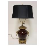 1163	ASIAN OXBLOOD TABLE LAMP W/BRASS FOO DOGS & GROTESQUE FACE ON BASE, APPROXIMATELY 29 IN HIGH