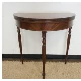 1088	MAHOGANY FLIP TOP ROUND GAME TABLE ON TURNED REEDED LEGS, APPROXIMATELY 15 IN X 30 IN X 31 IN H