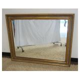 1093	HANGING MIRROR W/BEVELED EDGE IN ORNATE GILT FINISHED FRAME, APPROXIMATELY 48 IN X 38 IN