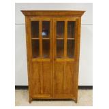 1288	BENCH MADE MAPLE & TIGER MAPLE TWO DOOR NARROW CUPBOARD W/ LOWER PANELED SIDES W/ THREE SHELVES