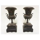 1094	PAIR OF MINIATURE METAL URNS ON SLATE BASES, APPROXIMATELY 9 1/2 IN HIGH