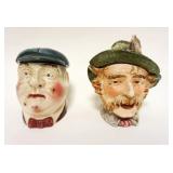 1047	2 FIGURAL TOBACCO JARS, MAN W/FEATHERS ON HAT HAS LOSSES TO TOP, APPROXIMATELY 6 3/4 IN HIGH