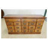 1261	SOLID OAK 18 DRAWER STORE KEEPERS COUNTER TOP CABINET, APPROXIMTELY 62 IN X 17 IN X 34 IN H