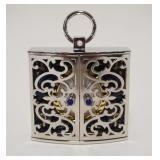 1031	MIKIMOTO CLOCK IN FRETWORK DOUBLE DOOR CASE MARKED SILVER, APPROXIMATELY 1 IN X 3 IN X 4 IN H