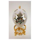1034	FABERGE WINTER SCENE PORCELAIN EGG ON GILT FINISHED METAL STAND WITH BIRD ON SNOW COVRED BRANCH
