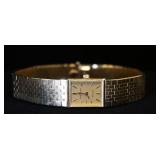 1171	14K GOLD BAUME & MERCIER LADIES WRIST WATCH W/ TIFFANY & CO. ON THE DIAL W/ BOX APP. 8 1/2 IN L