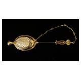 1200	18KT YELLOW GOLD BROOCH, 9.10 DWTS & CONTAINING ONE BLACK CABOCHON STONE & CAMEO PRESSED INTO G