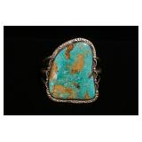 1253	STERLING SILVER CUFF BRACELET W/LARGE TURQUOISE MEASURING 2 1/2 IN X 33/4 IN, SMALL CRACK IN TH