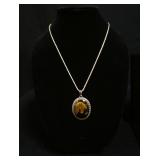1296	STERLING SILVER NECKLACE W/STERLING PENDANT CONTAINING A COBACHON CUT AMBER W/INTRICATE REVERSE