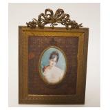 1028	ARTIST SIGNED HAND PAINTED IMAGE OF YOUNG WOMAN IN ORNATE BRASS FRAME, APPROXIMATELY 5 1/2 IN X
