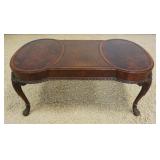 1222	CARVED MAHOGANY COFFEE TABLE WITH BURLED MEDALLION TOP AND LEAHTER CENTER, APPROXIMATELY 40 IN 