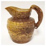 1007	ANTIQUE POTTERY HOUND HANDLED PITCHER, RELIEF HUNT SCENE OF DOGS, STAG & WILD BEAR, APPROXIMATE