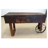 1103	PRIMITIVE WOOD INDUSTRIAL/FLORIST STYLE CART W/ONE DRAWER & METAL WHEEL, APPROXIMATELY 55 IN X 
