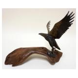 1129	BRONZE EAGLE ON WOOD BASE, APPROXIMATELY 15 IN X 11 1/2 IN HIGH
