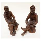 1132	CARVED WOOD FOLK ART FIGURES OF MAN SITTING ON TREE STUMPS, APPROXIMATELY 9 IN HIGH