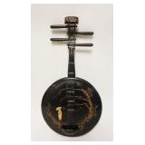 1231	BLACK LACQUERED ASIAN WALL HANGING IN THE FORM OF A BANJO, APPROXIMATELY 12 IN X 24 IN