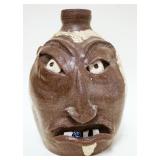 1051	FACE JUG *NO RAISE* ARTIST STAMPED ON BACK, APPROXIMATELY 12 IN HIGH